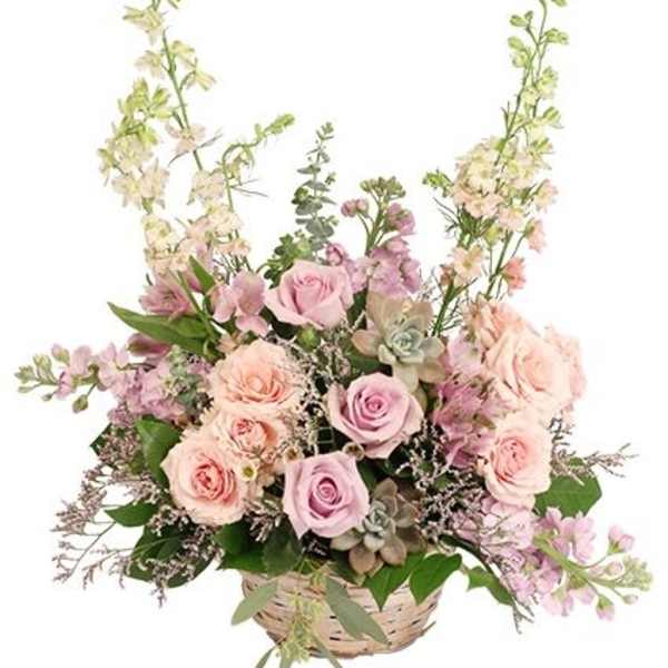 Basket arrangement of pink roses and lavender flowers