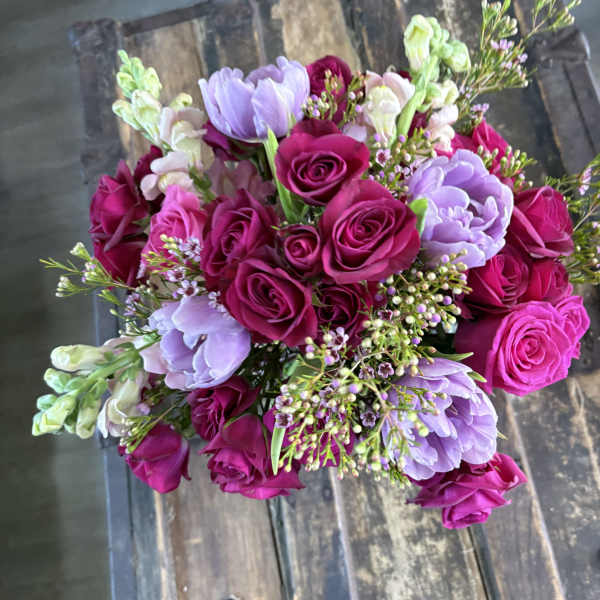 Bouquet of magenta roses and lavender flowers