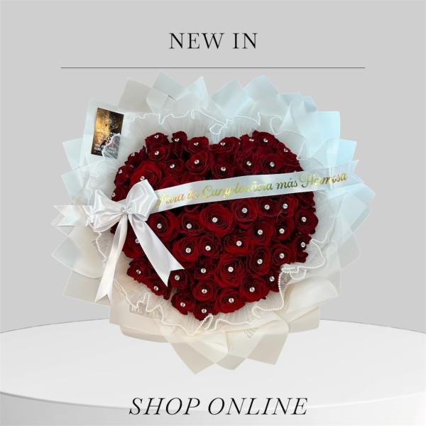 Heart-shaped bouquet of red roses with a white ribbon and sheer wrapping