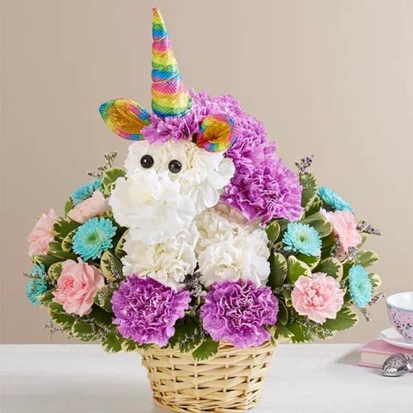 Unicorn-shaped flower basket with rainbow horn and pastel blooms