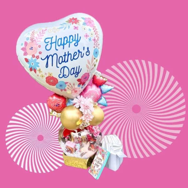 Mother's Day balloon bouquet with gift items on a pink background