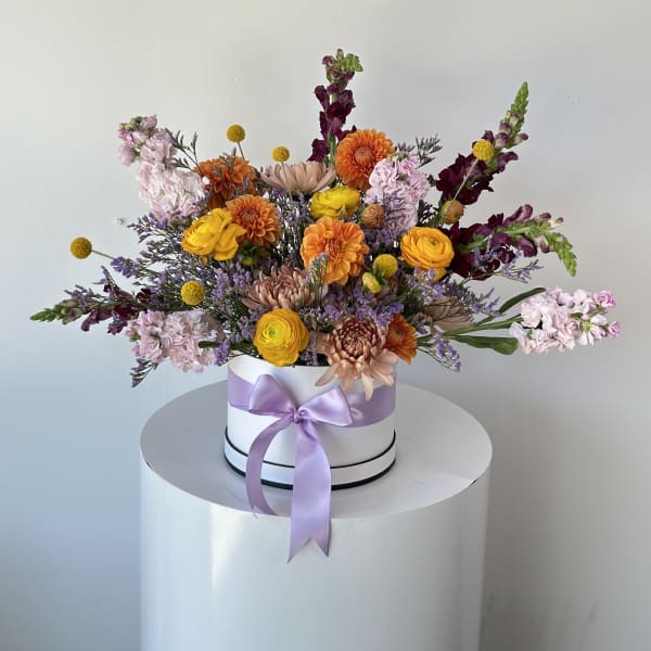 Mixed bouquet in a white hat box with a lavender ribbon