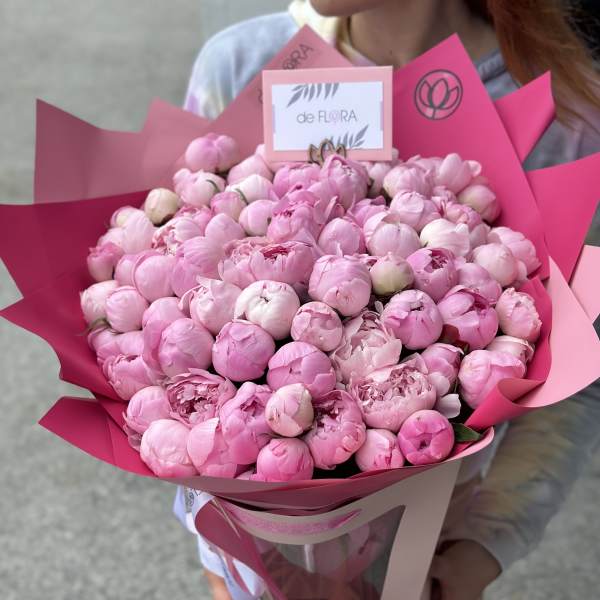 Large bouquet of pink peonies wrapped in bright pink paper