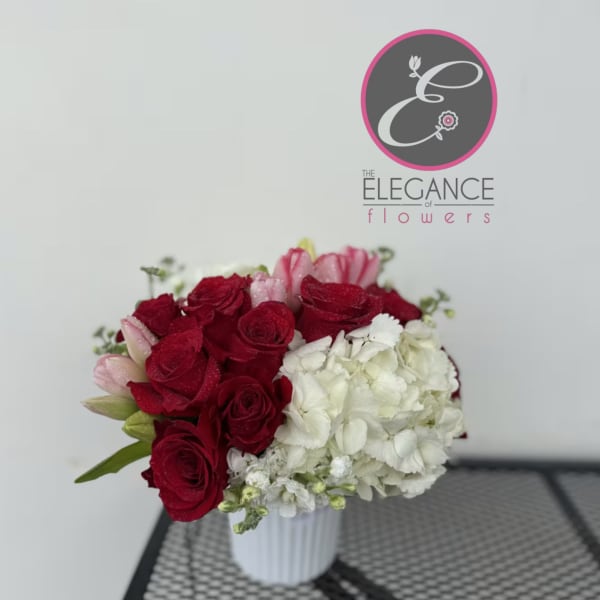 Red roses and white hydrangeas in a white vase
