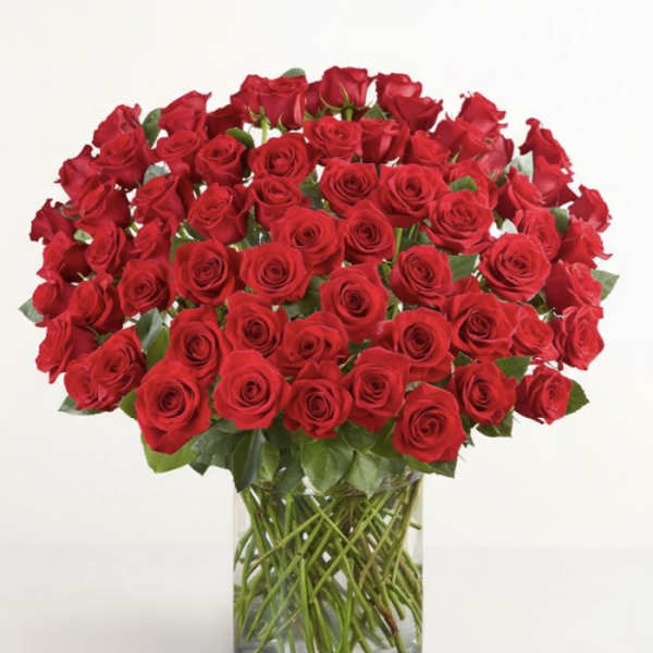 Large bouquet of red roses in a clear glass vase