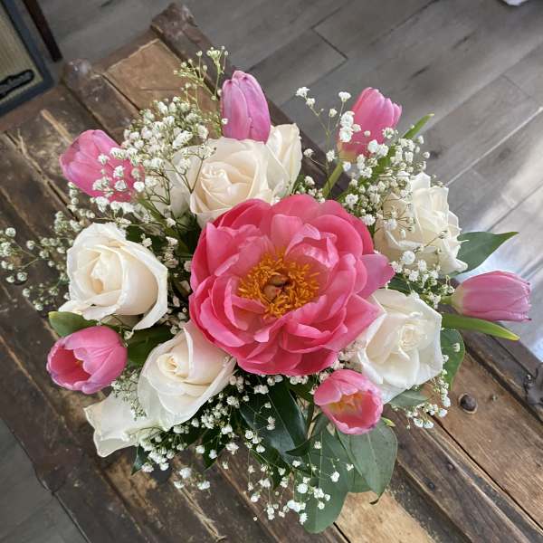 Bouquet of pink tulips, white roses, and a large pink peony