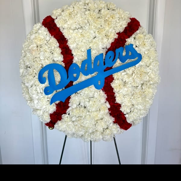 Round white floral wreath with red stripes and a blue Dodgers sign