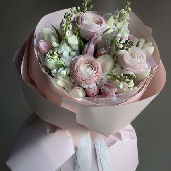 Pink and white bouquet wrapped in pale pink paper