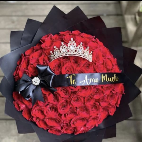 Round bouquet of red roses with a tiara and black ribbon