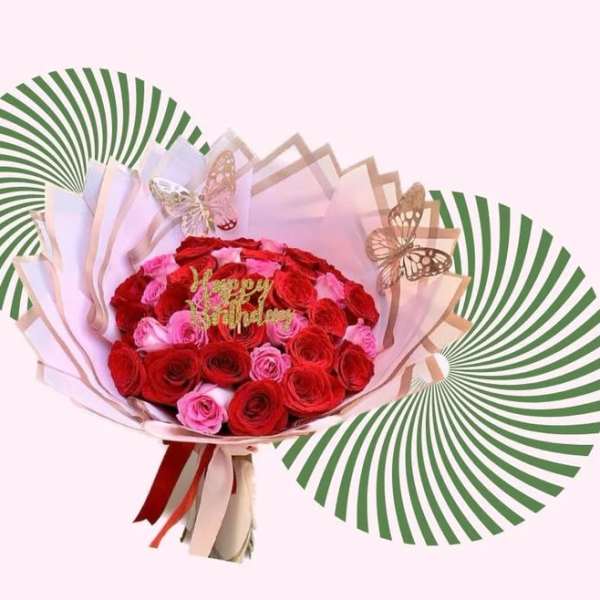 Bouquet of red and pink roses with butterfly decorations
