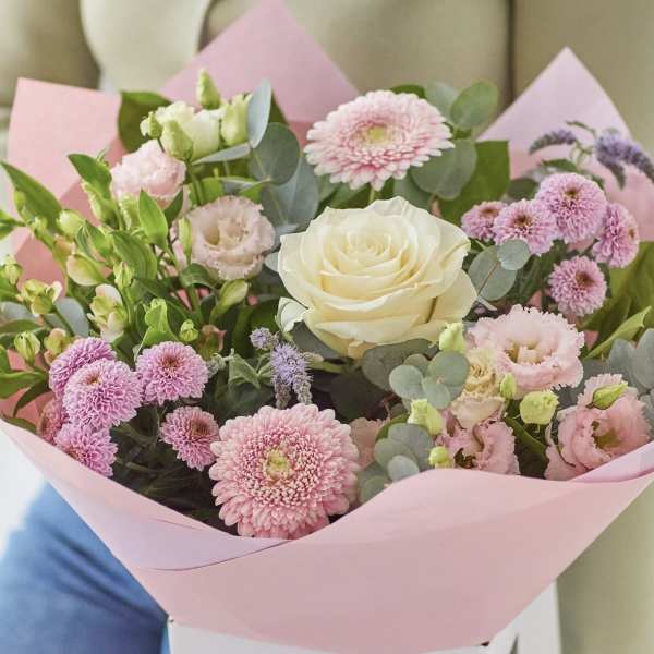 Pink and white mixed bouquet with a cream rose in pink paper