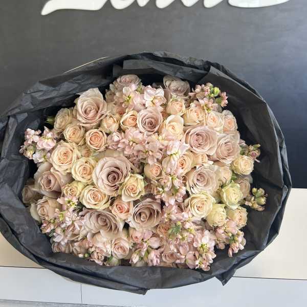 Large bouquet of pale pink and cream roses with small pink filler flowers