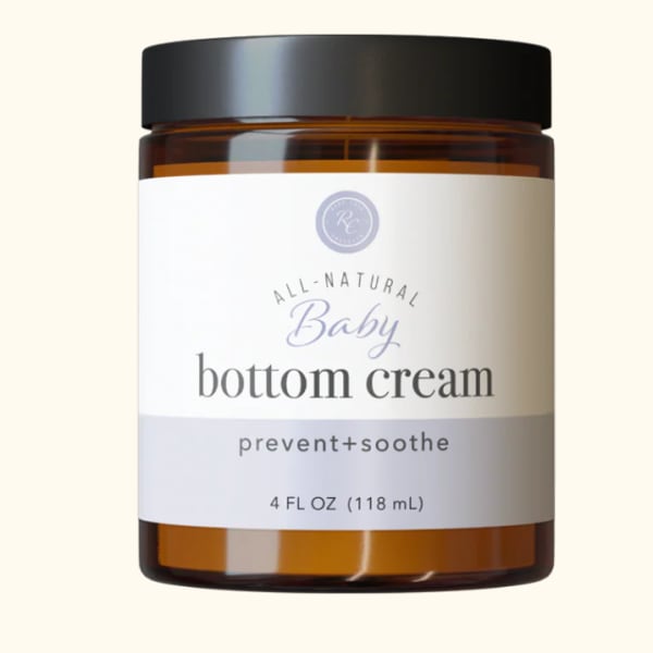 Amber jar of baby bottom cream with a black lid
