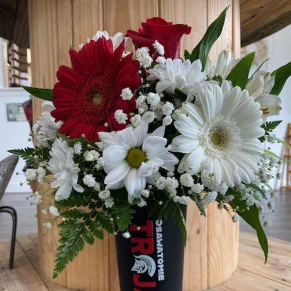 Red and white mixed bouquet in a black vase