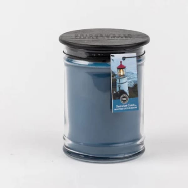 Blue candle in a glass jar with a black lid
