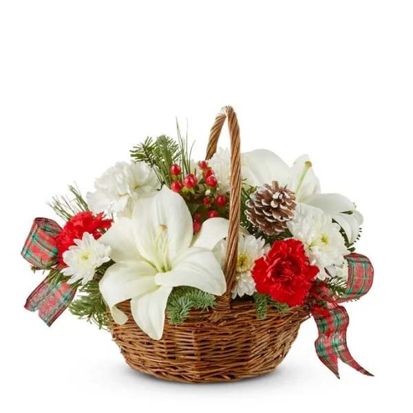 White lilies and red carnations in a wicker basket with plaid ribbon