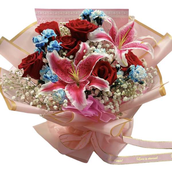 Bouquet of red roses and pink lilies wrapped in pink paper