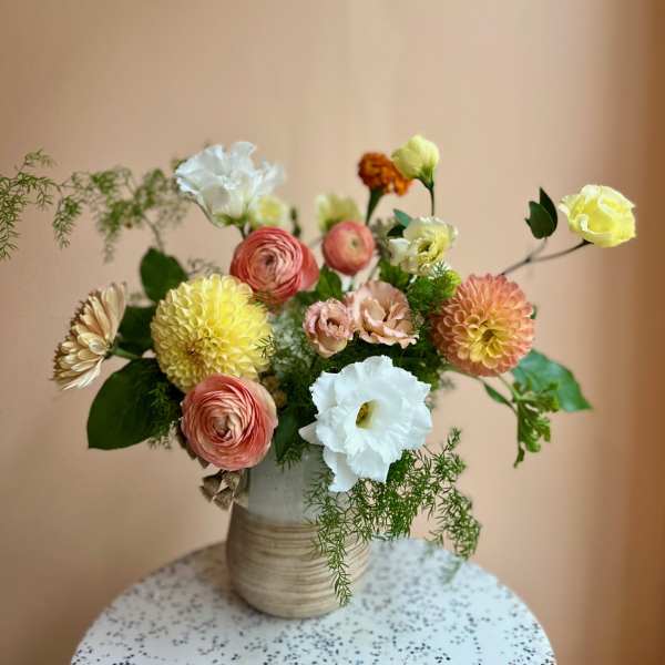Mixed pastel flower arrangement in a ceramic vase