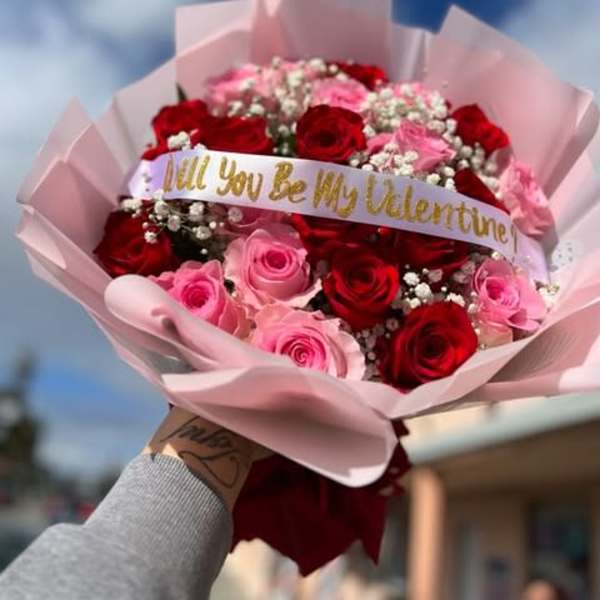 Bouquet of red and pink roses with a Valentine ribbon