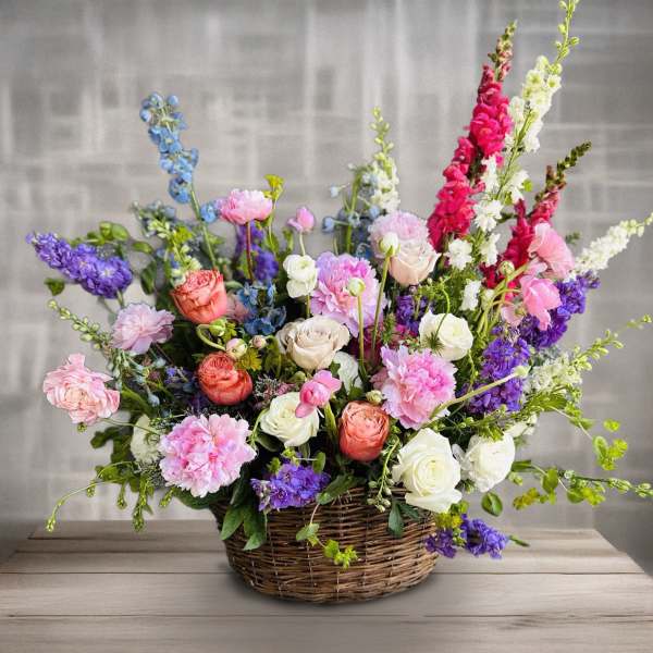 Colorful mixed flower arrangement in a wicker basket