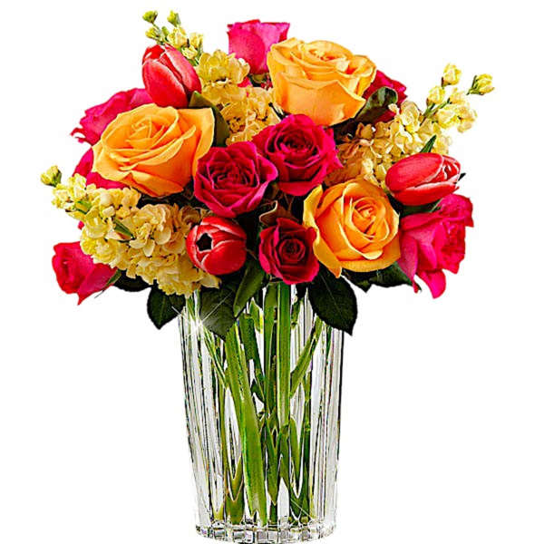Bouquet of pink, red, and yellow roses in a clear glass vase