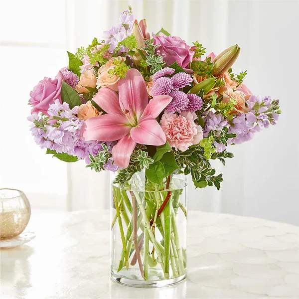 Pink and lavender mixed bouquet in a clear glass vase