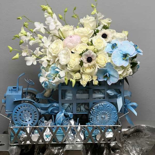 Blue and white floral arrangement in a decorative metal cart