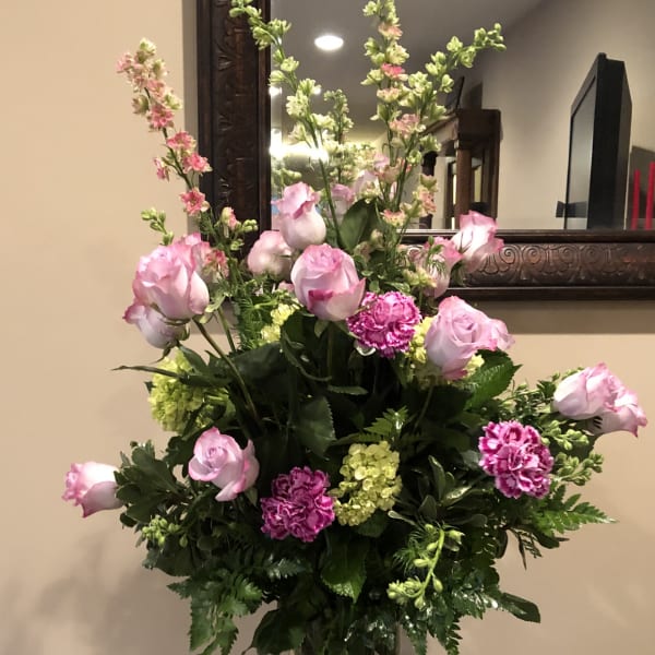 Pink roses and carnations in a clear glass vase