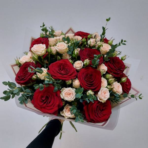 Bouquet of red and blush roses with eucalyptus wrapping