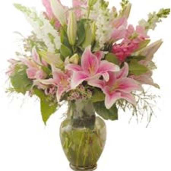 Pink lilies arranged in a glass vase