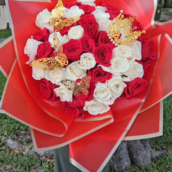 Red and white rose bouquet with gold butterfly decorations