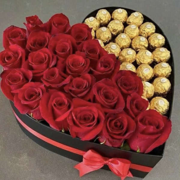 Heart-shaped box of red roses and gold-wrapped chocolates