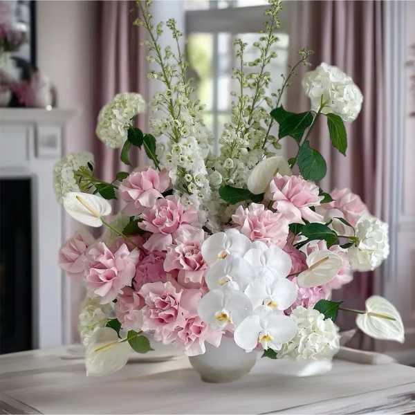 Pink and white floral arrangement in a white vase