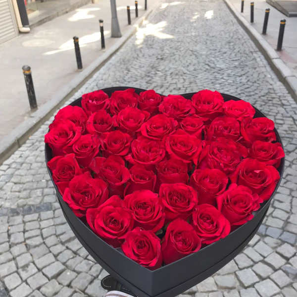 Heart-shaped box filled with red roses