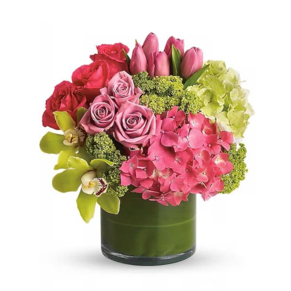 Pink and red flower arrangement in a green vase