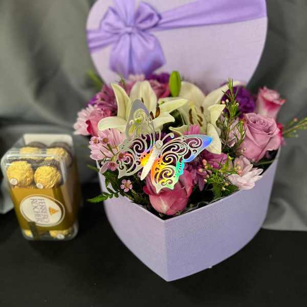 Lavender heart box with pink and white flowers and a butterfly pick