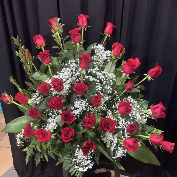 Large arrangement of red roses with white baby's breath