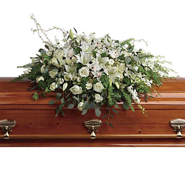 White floral casket spray with roses and lilies