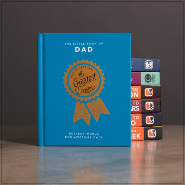 Blue gift book titled "The Little Book of Dad" with stacked books behind it
