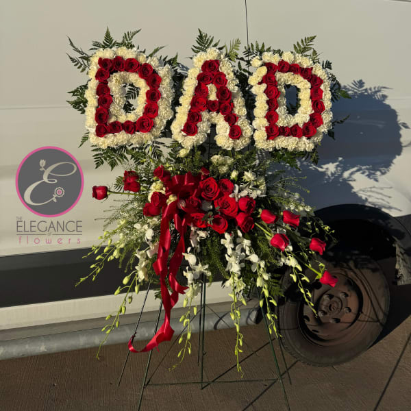 Floral standing arrangement spelling "DAD" with red and white roses