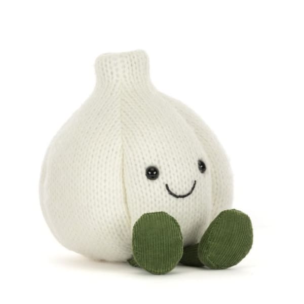 Plush garlic-shaped toy with a smiling face and green feet