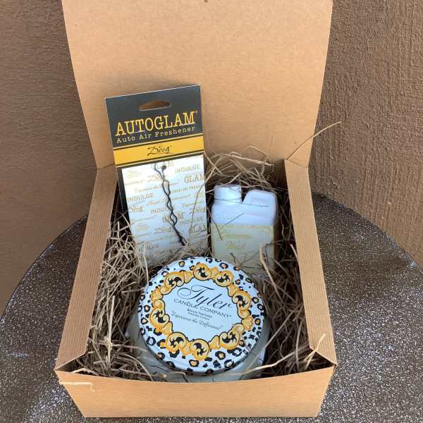 Gift box with a candle, air freshener, and small bottle of wash