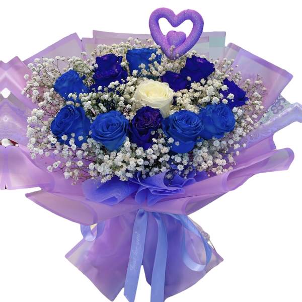 Bouquet of blue and purple roses with baby's breath and a heart topper