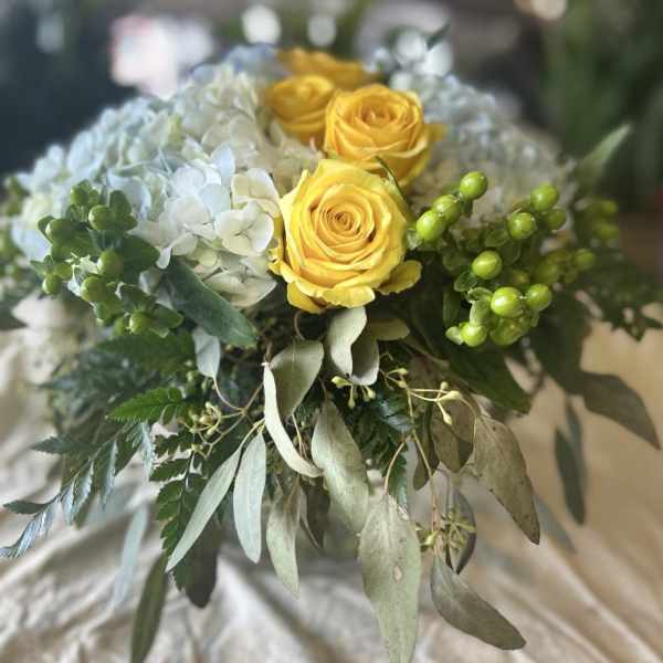 Bouquet of yellow roses and white hydrangea with greenery