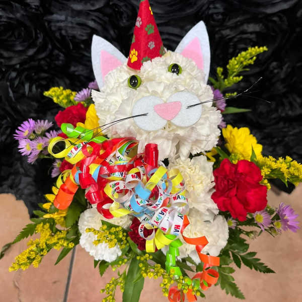 Cat-shaped floral arrangement with a party hat and colorful ribbon curls