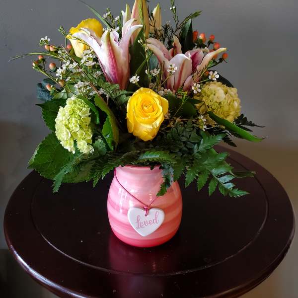 Pink vase arrangement with lilies, roses, and hydrangeas