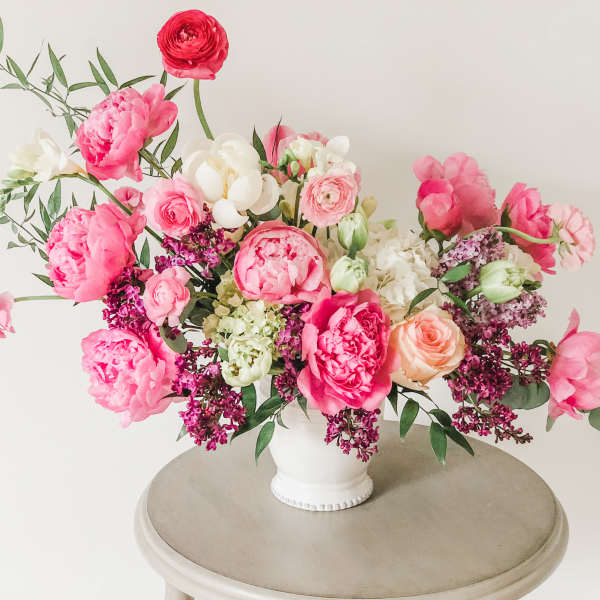 Pink and white floral arrangement in a white vase