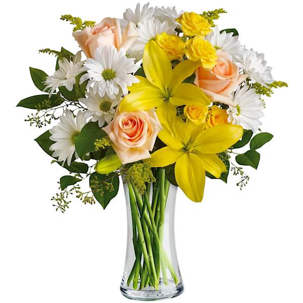 Bouquet of yellow lilies, peach roses, and white daisies in a clear glass vase
