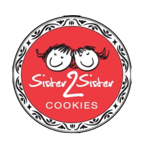 Round red cookie logo with two smiling faces and the words Sister 2 Sister Cookies