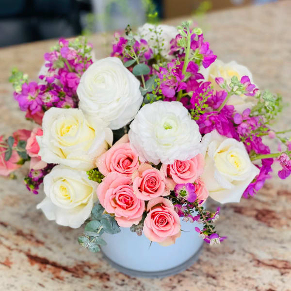 Bouquet of pink and white roses in a white vase